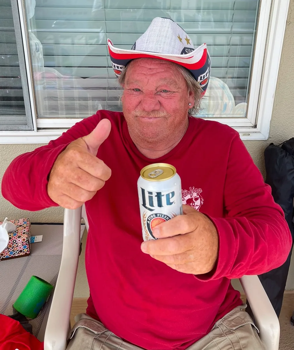 Scott giving a thumbs up while holding a miller lite
