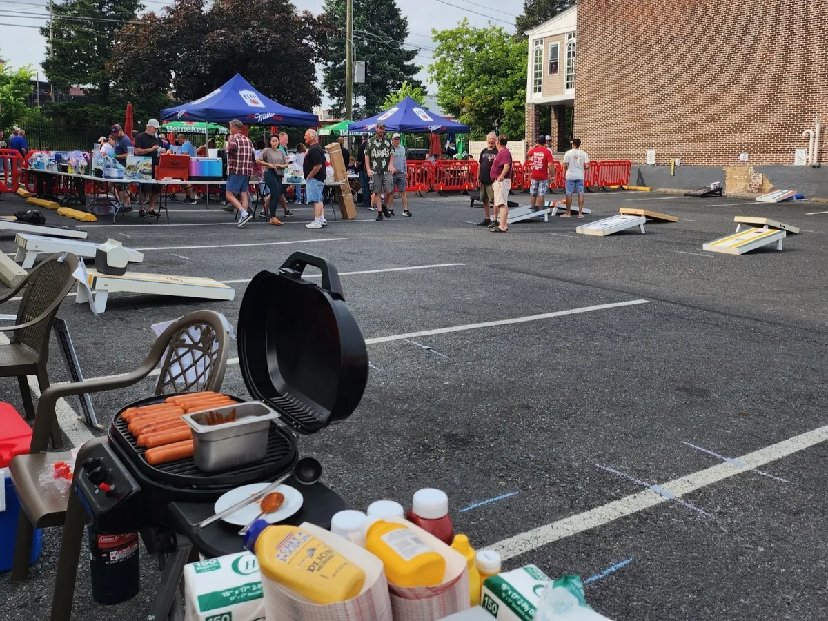 View of the tournament setup with crowd and cornhole boards