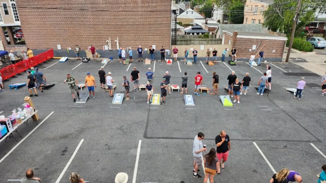 A view of people playing cornhole.